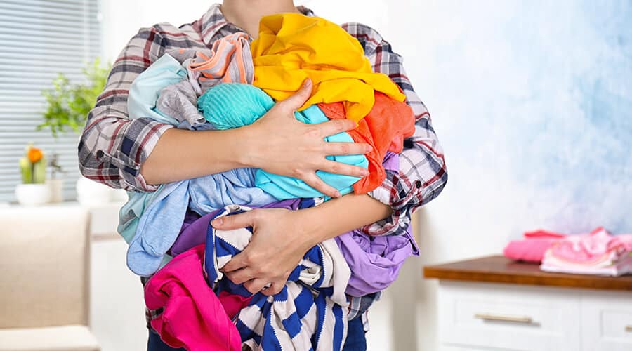 A person holding a bundle of washing
