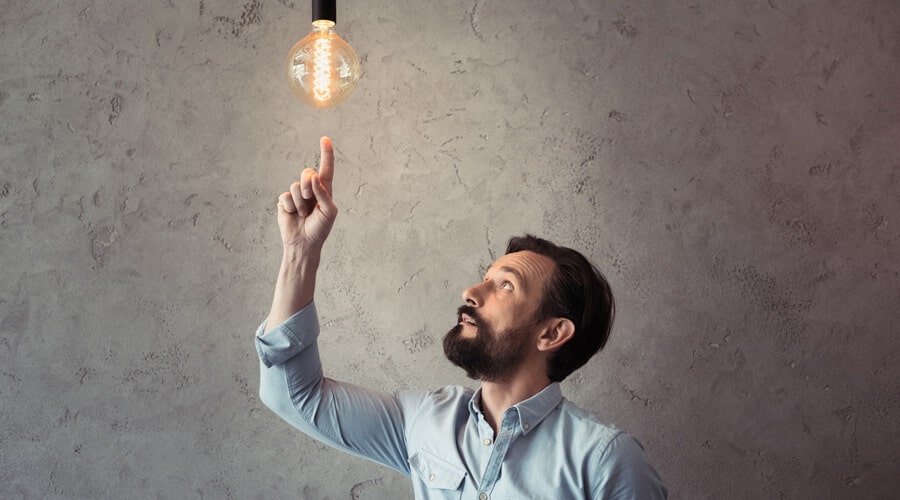 Man pointing at light bulb